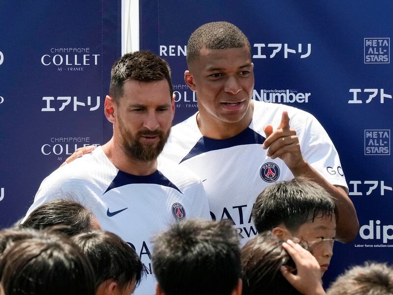 Paris Saint-Germain's Kylian Mbappe, right, and Lionel Messi. EPA