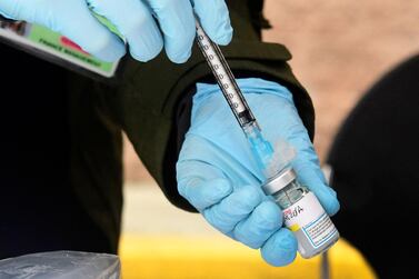 Nurse Emily Enos loads the Moderna Covid-19 vaccine into a syringe outside the Los Angeles Mission, in Skid Row, Los Angeles, on February 10, 2021 as part of an immunisation drive for homeless seniors AFP