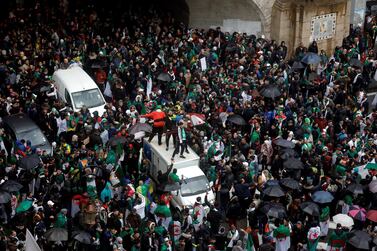 Demonstrators holding umbrellas take part in a protest calling on Algerian President Abdelaziz Bouteflika to quit, in Algiers on March 22, 2019. Reuters