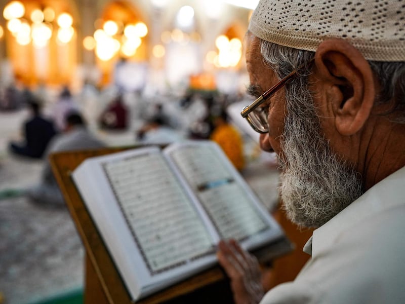 A worshipper reads the Quran at the Grand Mosque of Kufa near the central shrine city of Najaf, about 160 kilometres south of Iraq's capital Baghdad, during the month of Ramadan. AFP