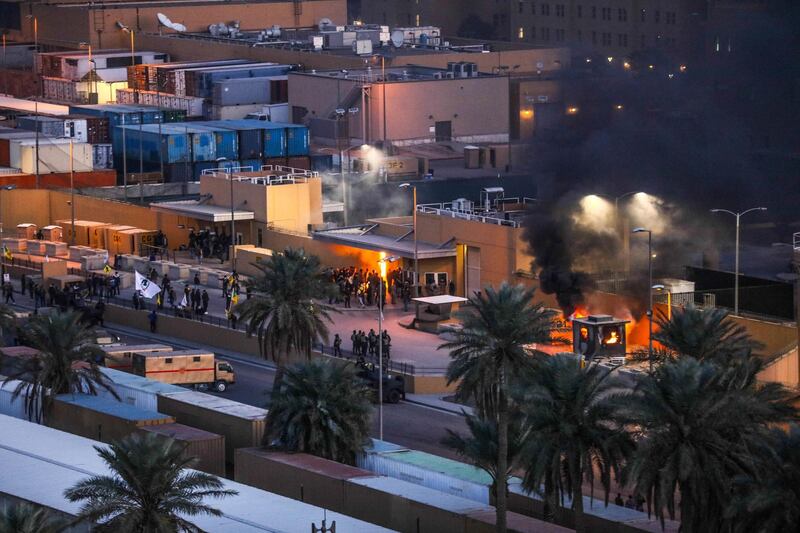 Protesters set fire to an entry control point at the US embassy in Baghdad, Iraq. Reuters