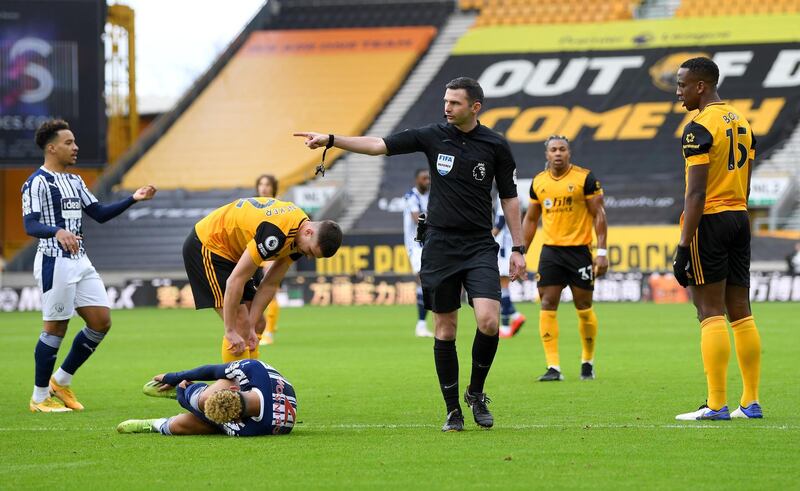 Referee Michael Oliver awards West Bromwich Albion their first penalty after Callum Robinson is fouled by Wolves defender Willy Boly. Getty