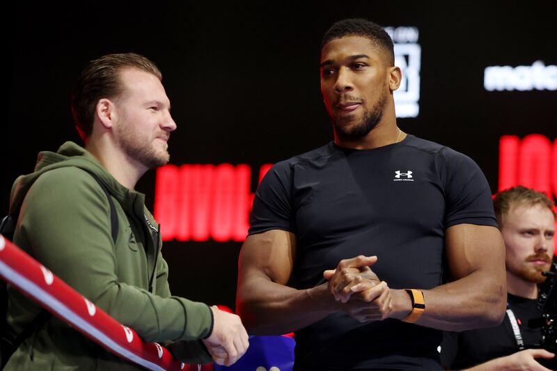 Anthony Joshua speaks to his head coach Ben Davison during the media workout ahead of his heavyweight fight against Otto Wallin at the Kingdom Arena in Riyadh, Saudi Arabia, on Saturday, December 23, 2023. AFP