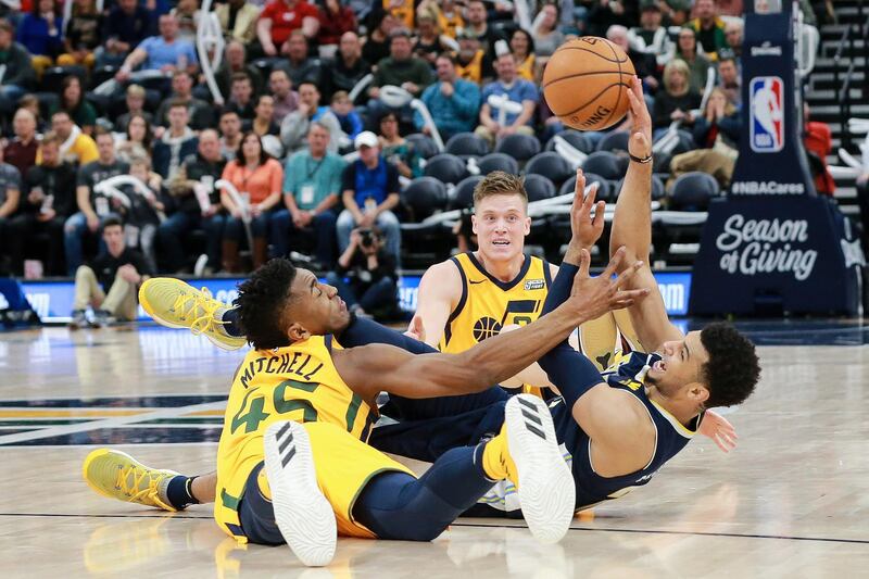 Utah Jazz guard Donovan Mitchell and Denver Nuggets guard Jamal Murray fight for the loose ball during the second half at Vivint Smart Home Arena. Chris Nicol / USA TODAY Sports