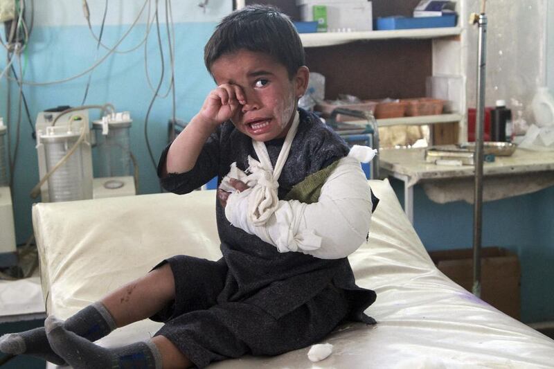 An injured boy sits on a bed following an attack, at a hospital in Ghazni city, Afghanistan. The attacks happened on the outskirts of the city, said deputy provincial governor, Mohammad Ali Ahmadi. Two women and a policeman were killed, while two policemen and six civilians, including three children, were wounded, added Ahmadi. Rahmatullah Nikzad / AP 