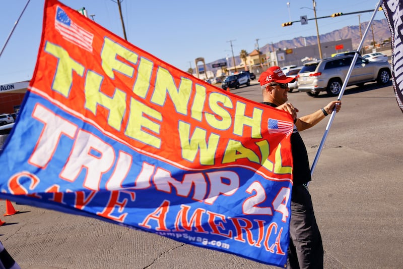 A supporter of former president Donald Trump stands near El Paso International Airport as President Joe Biden visits El Paso, Texas. Reuters