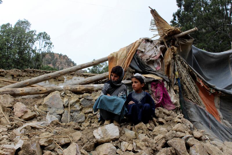 Afghan boys site near their damaged house that was destroyed in an earthquake in the Spera District of the southwestern part of Khost Province, Afghanistan. AP