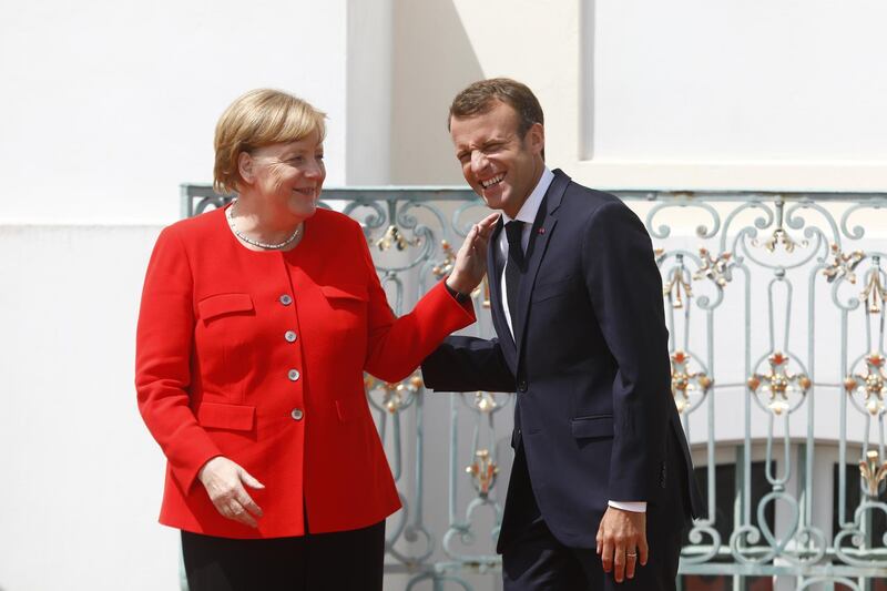 GRANSEE, GERMANY - JUNE 19: German Chancellor Angela Merkel greets French President Emmanuel Macron at Schloss Meseberg governmental palace during German-French government consultations on June 19, 2018 near Gransee, Germany. Merkel, Macron and a selection of their government ministers are coming together today for a day of talks. (Photo by Michele Tantussi/Getty Images) *** BESTPIX ***