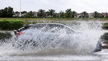 A car drives through water in a flooded street following heavy rains in Dubai, United Arab Emirates, April 16, 2024.  REUTERS / Amr Alfiky