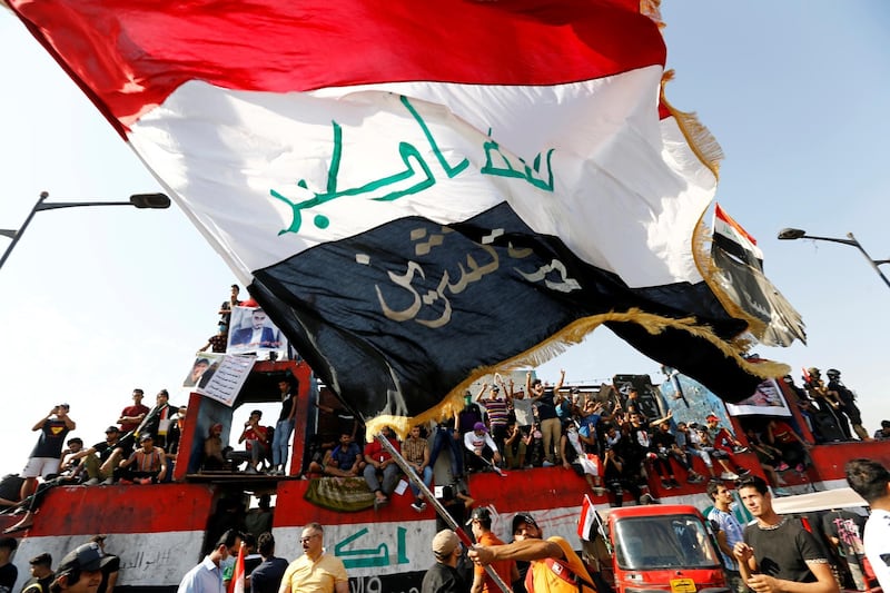 Iraqi demonstrators gather to mark the first anniversary of the anti-government protests in Baghdad, Iraq October 25, 2020. REUTERS/Thaier Al-Sudani
