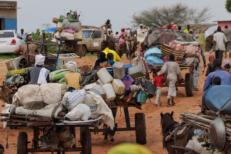Chadian cart owners transport the belongings of Sudanese refugees who fled the conflict in Sudan's Darfur region. Reuters