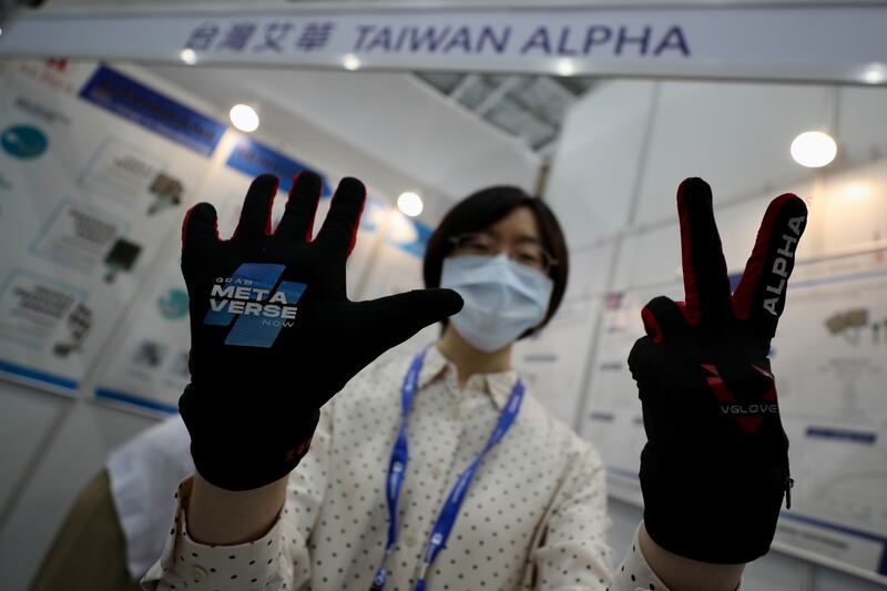 People in the metaverse wear special gloves that can "virtually feel" touch. EPA