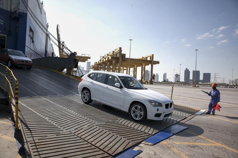Brand new BMW cars roll off the Glovis Passon roll-on roll-off ship at Port Zayed in Abu Dhabi. Silvia Razgova / The National