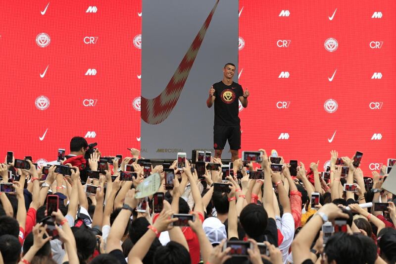 Ronaldo gestures as fans take photos of him. Reuters