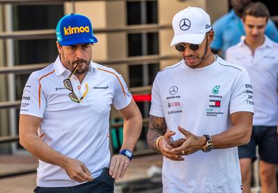 epa07182871 Spanish Formula One driver Fernando Alonso (L) of McLaren and British Formula One driver Lewis Hamilton (R) of Mercedes AMG GP arrive at the circuit ahead of the Abu Dhabi Formula One Grand Prix 2018 at Yas Marina Circuit in Abu Dhabi, United Arab Emirates, 22 November 2018. The Formula One Grand Prix of Abu Dhabi will take place on 25 November 2018.  EPA/SRDJAN SUKI