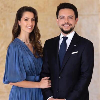 Princess Rajwa wore a blue pleated dress by Greek brand Costarellos, with a pearl necklace, in a photo announcing her engagement to Crown Prince Hussein. Photo: @alhusseinjo / Instagram