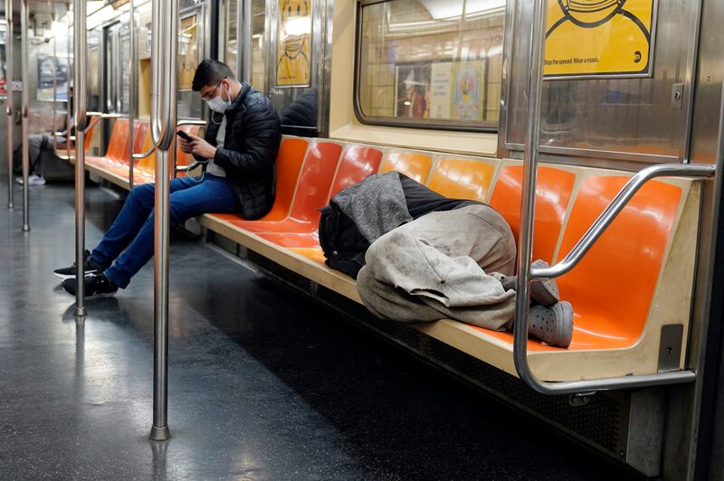 A man sleeping on a new York subway train. AP