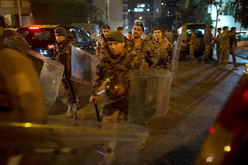 Lebanese security forces move into position outside of the home of newly-assigned Lebanese Prime Minister, Hassan Diab. AP