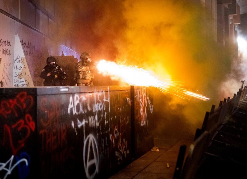 Federal officers use chemical irritants and crowd control munitions to disperse Black Lives Matter protesters in Portland. AP