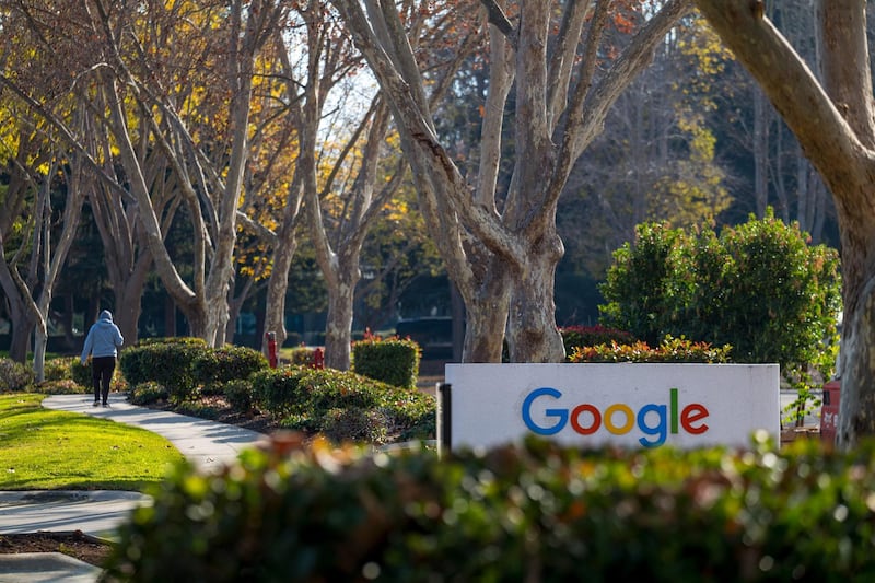 A pedestrian walks past a building at the Google campus in Mountain View, California, U.S., on Wednesday, Dec. 16, 2020. On Wednesday, Texas Attorney General Ken Paxton filed an antitrust lawsuit against Alphabet Inc.'s Google. At its center is a bold claim: Google colluded with archrival Facebook Inc. in an illegal deal to manipulate auctions for online advertising, an industry the two companies dominate. Photographer: David Paul Morris/Bloomberg