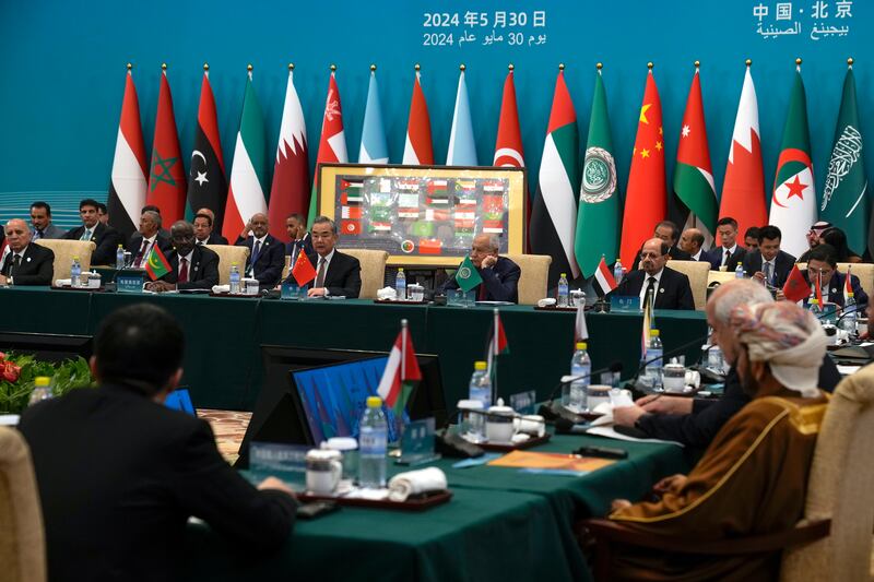Chinese Foreign Minister Wang Yi speaks to Arab League Secretary General Ahmed Aboul Gheit as he chairs the 10th ministerial meeting of the China-Arab States Co-operation Forum. AP