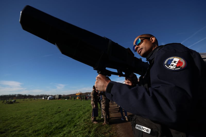 A French police officer demonstrates how an anti-drone gun works during a media presentation of security systems at a military base in Velizy-Vallacoublay, south-west of Paris. AFP