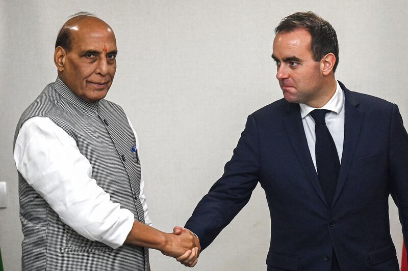 French Defence Minister Sebastien Lecornu, right, shakes hands with India's Defence Minister Rajnath Singh before a meeting in New Delhi on November 28, 2022. AFP