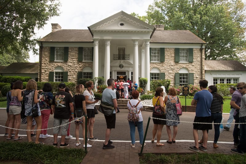 Fans wait in line outside Graceland. Presley died August 16, 1977. Brandon Dill / AP Photo