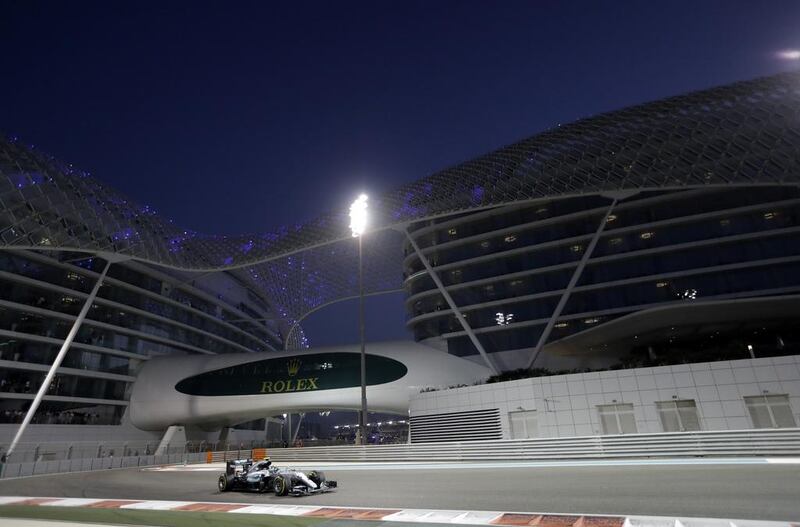 Nico Rosberg drives by the Yas Viceroy hotel. Luca Bruno / AP Photo