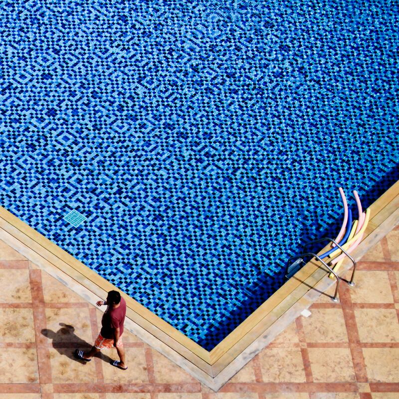 KHORFAKKAN, UAE. July 17, 2014 - Focal point - A man walks across a pool deck at Oceanic Hotel in Khorfakkan, July 17, 2014. (Photos by: Sarah Dea/The National, Story by: Standalone, Focal point)
