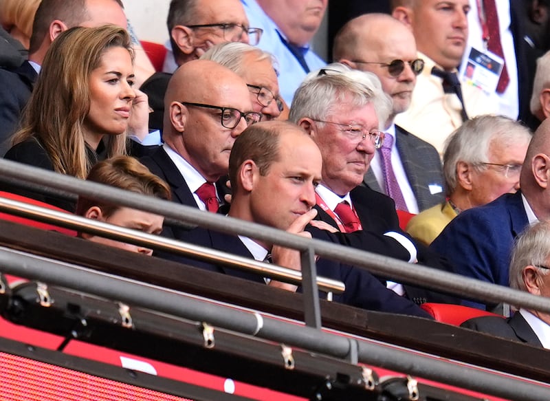 The Prince of Wales and Sir Alex Ferguson look on. PA