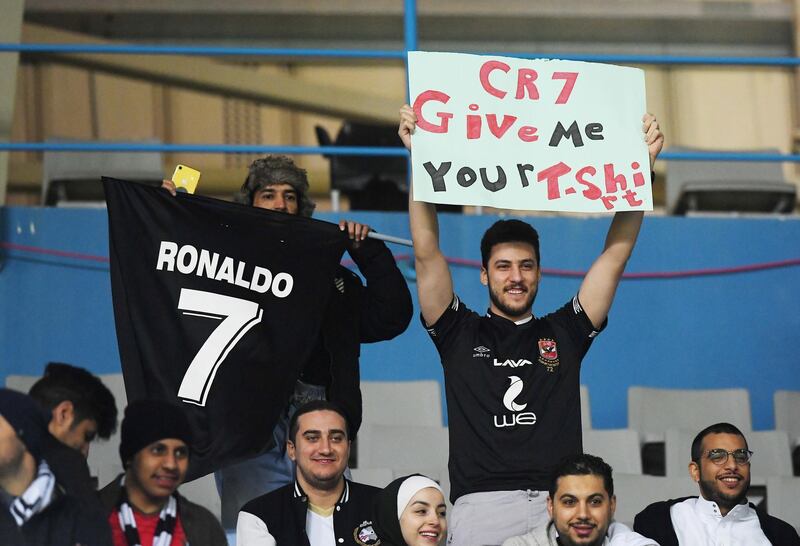 A Juventus fan holds up a sign for Cristiano Ronaldo before the match. Reuters