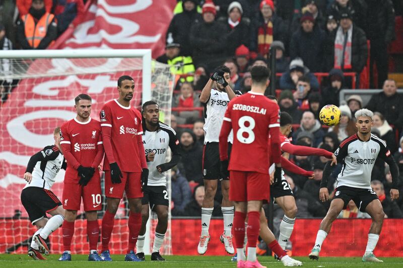 Liverpool's Trent Alexander-Arnold, partially hidden, curls home a free-kick for the opening goal. AFP