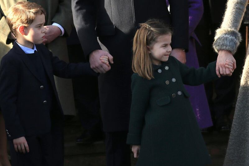 Britain's Prince William, Duke of Cambridge and Catherine, Duchess of Cambridge hold the hands of their children Prince George and Princess Charlotte after attending a Christmas day service at the St Mary Magdalene Church. AP