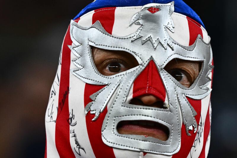 A fan of USA with a mask waits on the stands ahead of the Qatar 2022 World Cup Group B football match between USA and Wales at the Ahmad Bin Ali Stadium in Al-Rayyan, west of Doha on November 21, 2022.  (Photo by Jewel SAMAD  /  AFP)