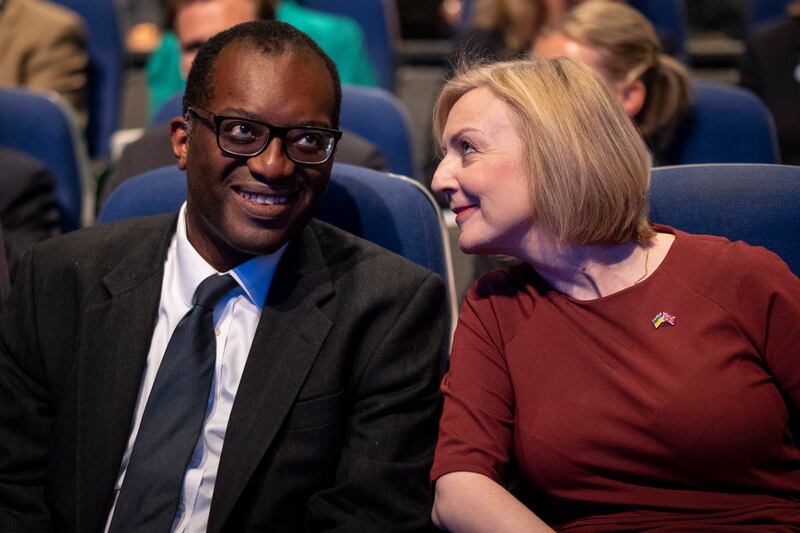 Ms Truss and Mr Kwarteng chat at the opening session of Conservative Party conference in Birmingham. EPA