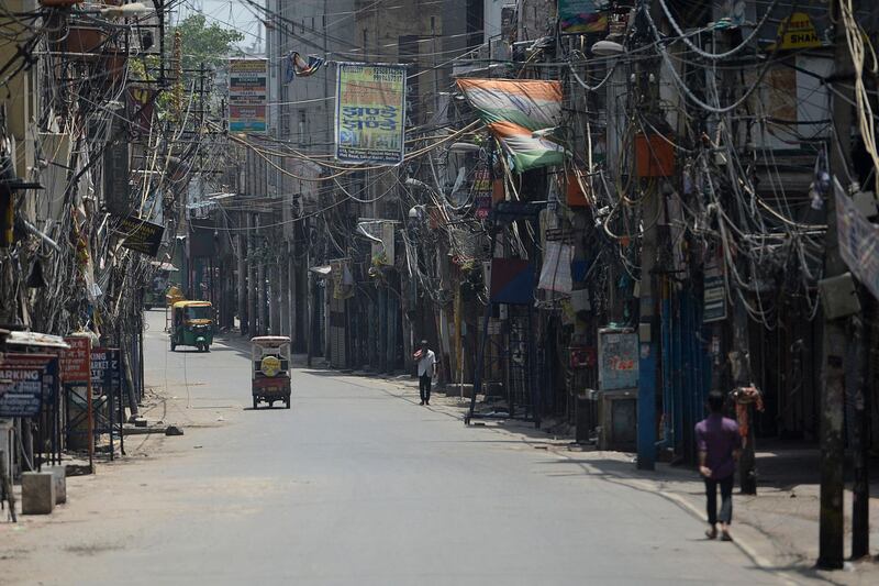 People walk down an alley in New Delhi during a lockdown as coronavirus case numbers increase. AFP