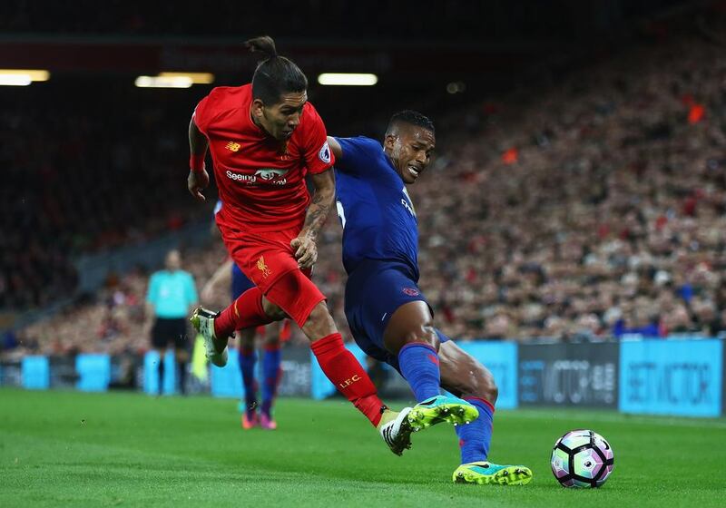 Antonio Valencia of Manchester United, right, is tackled by Roberto Firmino of Liverpool during the Premier League match  at Anfield on October 17, 2016 in Liverpool, England. Clive Brunskill / Getty Images