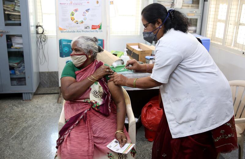 epa09076015 A woman receives a dose of a vaccine against COVID-19 during a vaccination campaign at Dasappa Hospital in Bangalore, India, 15 March 2021. India recorded its highest single-day spike this year with over 25,000 covid-19 cases reported from all over the India and mainly from Maharastra state.  EPA/JAGADEESH NV