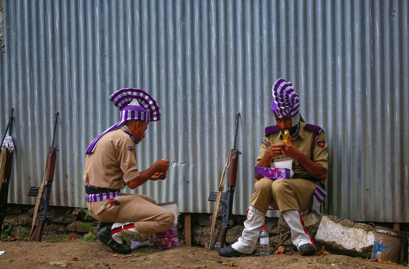 Police officers in ceremonial dress relax after taking part in a parade to celebrate the 75th anniversary of Indian independence, in Srinagar. EPA