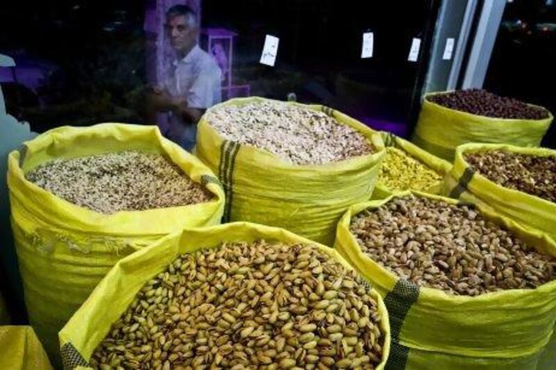 An Iranian man looks at nuts for sale at a nut shop, in western Tehran. Pistachios are Iran's top non-oil export and provide work for hundreds of thousands of people.
