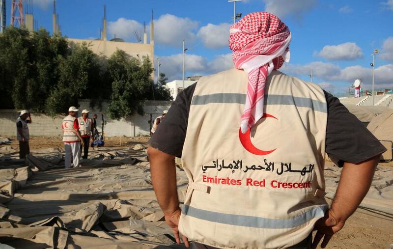 Emirates Red Crescent volunteers work at the site of Emirates field hospital in Deir al-Balah in central Gaza Strip.