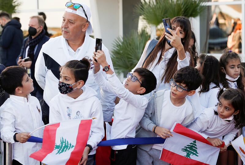 Children holding Lebanese flags wait for Pope Francis at Larnaca International Airport. Reuters