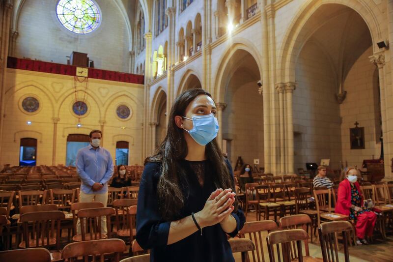 A Christian worshipper wearing a mask to prevent the spread of COVID-19, prays for the victims of the deadly blast in Beirut. AP Photo
