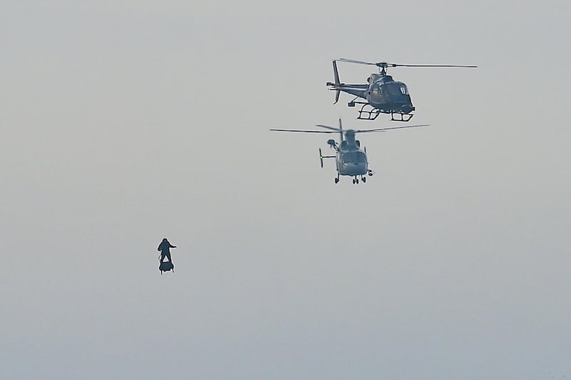 Helicopters keep an eye on the inventor. AFP