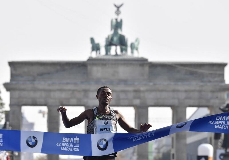 Ethiopian Kenenisa Bekele after crossing the finish line to win the 43rd Berlin Marathon in Berlin on September 25, 2016. John MacDougall / AFP