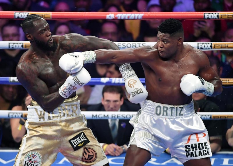 LAS VEGAS, NEVADA - NOVEMBER 23: Deontay Wilder (L) and Luis Ortiz battle in the second round of their WBC heavyweight title fight at MGM Grand Garden Arena on November 23, 2019 in Las Vegas, Nevada. Wilder retained his title by seventh-round knockout.   Ethan Miller/Getty Images/AFP