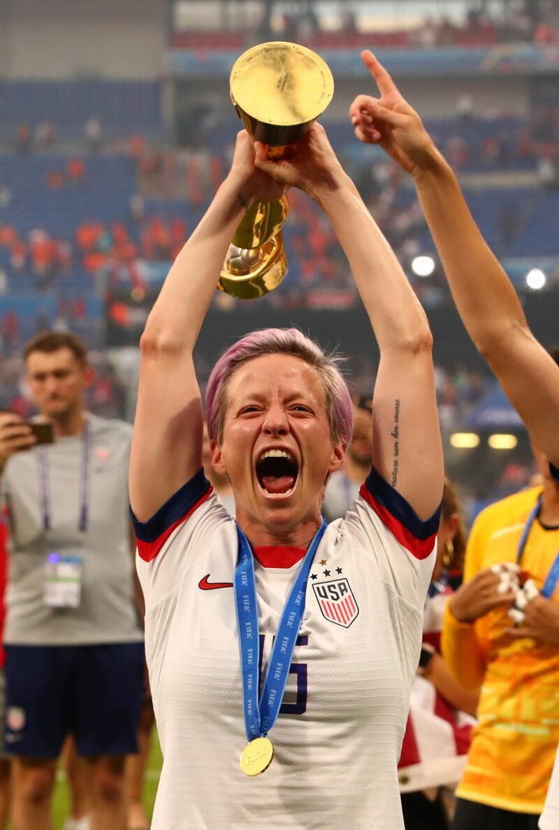 Rapinoe celebrates with the trophy. Reuters