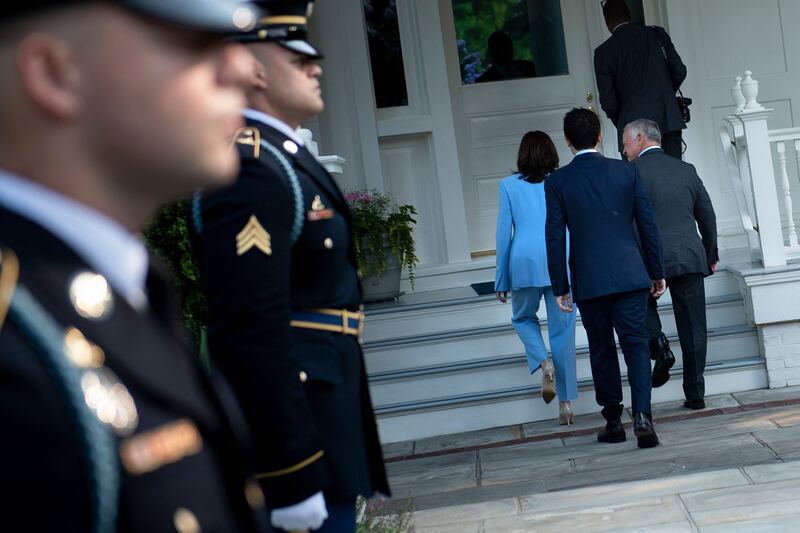 US Vice President Kamala Harris walks with Jordan's Crown Prince Hussein and Jordan's King Abdullah II to a meeting in Washington.