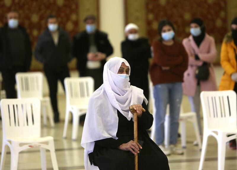 A woman sits as she waits to get tested for the coronavirus disease in the town of Hasbaya, Lebanon. Reuters